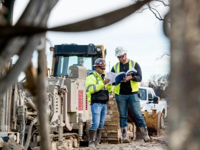 Keller employees looking at plans on site